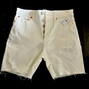 White denim button fly shorts with gold grommets